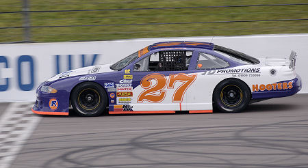 Duncan Gray crossing the finishing line in the SCSA Team Torquespeed No 27 Stock Car in 2004